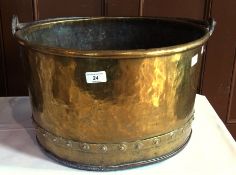 A large brass circular bucket, with handle and relief stud border, 44cm diameter