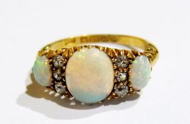 Edwardian 18ct gold, diamond and opal ring, set large oval opal and  further opals interspersed by