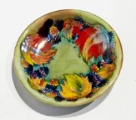 Moorcroft flambe "Leaf and Berry" shallow dish with everted rim, slip-trailed and painted decoration