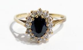 9ct gold dress ring, set with central sapphire coloured stone, surrounded by claw set white stones