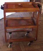 An Art Deco two-tier trolley, with lift-up tray, black painted handles, on straight supports and