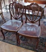 A pair of mahogany dining chairs, with shaped pierced back to leather studded seat, on cabriole