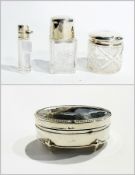 A George V oval silver trinket box, Birmingham 1913, together with two silver-capped glass jars, and