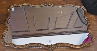 A gilt framed mirror, rectangular-shaped, floral decorated, 72cm wide