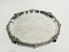 A George V silver presentation salver, with gadrooned shell wavy border, on scrolled legs, London