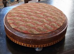 A Victorian mahogany footstool, with satinwood inlay, on bun feet, 28cm diameter