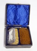 An Edwardian silver-backed gentleman's hairbrush set, comprising two silver backed hairbrushes and a