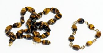 Tiger's eye and gold-coloured metal bracelet, the polished tiger's eye stones interspersed by gold-