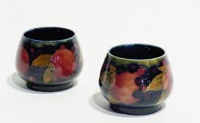 Pair early Moorcroft pottery "Pomegranate" vases, bulbous and footed, each with typical decoration