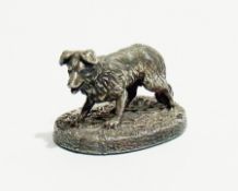 A modern miniature silver model of a dog, raised on an oval base, length 5cm