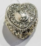 A Victorian silver heart-shaped pill box, with scrollwork repousse decoration, London 1893, 4cm