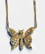 Gold and pave set diamond butterfly pendant, on integral fine curblink chain