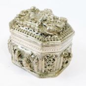 An Eastern silver-coloured metal octagonal box and cover, with heavy repousse decoration of