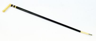 A late 19th century/20th century ebony and ivory walking stick, the turned tapering ebony stick with