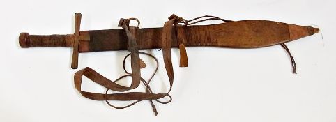 An Eastern short sword with leather scabbard and hilt