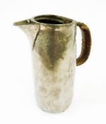 A Tudric pewter Art Nouveau hot water jug designed by Archibald Knox, hammered-finished with