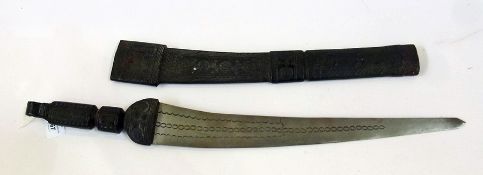 A tribal curved short sword with a leather hilt and scabbard