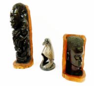 An African hardwood sculpture of head and figures, another hardwood sculpture of a head and a carved