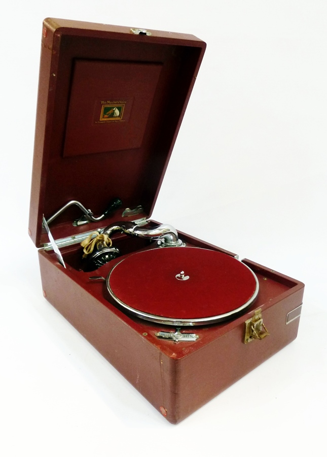 An HMV red portable wind-up gramophone, 78rpm, in a red case with carrying handle