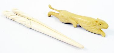 A pair of ivory glove stretchers, with twisted relief handles and an ivory cutlery rest in the shape