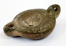 Roman earthenware oil lamp with embossed decoration 8.5cm