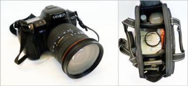 A Minolta Dynax 700SI single lens reflex camera, SLR, 35mm with a 28-300mm lens, filters, etc.