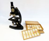 A Cooke Troughton and Simms microscope in a fitted wooden box together with a quantity of slides
