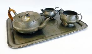 A hammered pewter teaset comprising:- teapot, milk jug and sugar basin with matching rectangular