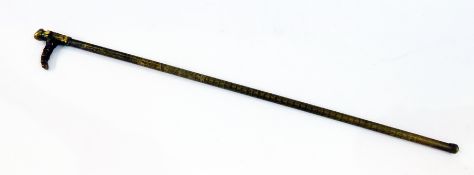 An Eastern brass walking stick, with hollow interior and bearded figure handle