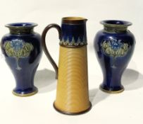 A pair of Royal Doulton stoneware vases, inverse baluster-shaped, dark blue ground with incised