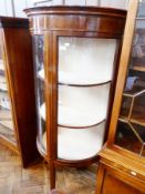 An Edwardian mahogany bow-fronted china cabinet with satinwood and ebony stringing, a pair of