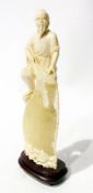 Japanese ivory fisherman the fisherman standing on rock holding finely carved fishing net, on