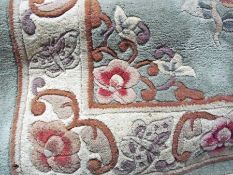 Three Chinese wool carpets, two green ground with foliate decoration and one yellow ground with
