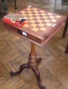 A mahogany games table, for chess and draughts, with single frieze drawer, ebony handle, on turned