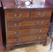 A modern mahogany chest of two short and three long drawers, on bracket feet, with brass swan-neck