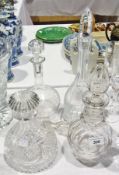 A cut glass decanter, two moulded glass decanters, an etched glass decanter and another stopper (5)