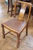 Set of four oak dining chairs with carved, pierced panel back, inset leather seat, on turned
