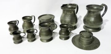 Two large pewter measures, pewter inkwells and other measures