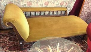 A Victorian mahogany chaise-longue, with green upholstery, pierced open armrest, on turned supports