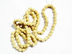 A carved bone beaded necklace