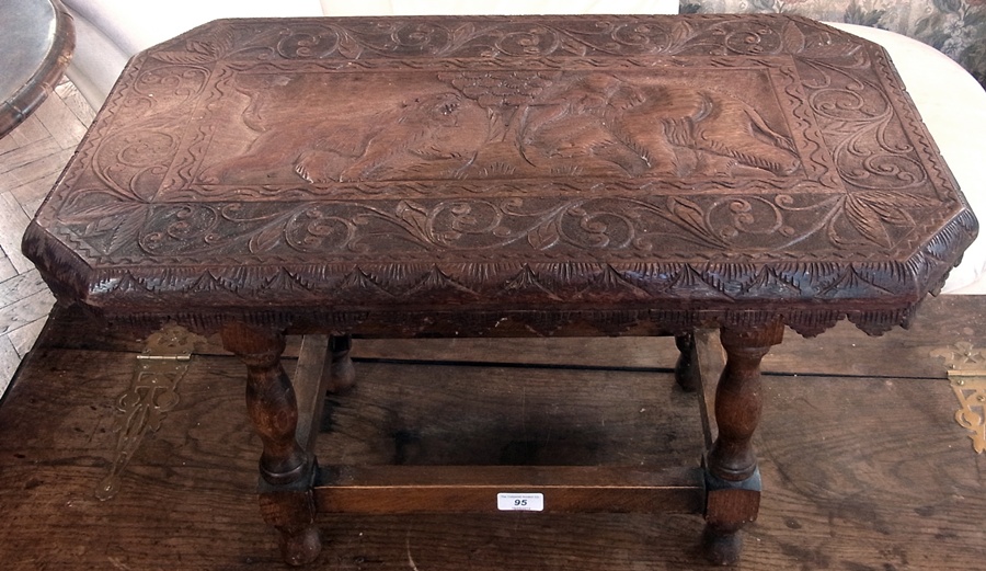 Indian carved hardwood occasional table, octagonal-shaped top, decorated with tiger and elephants on