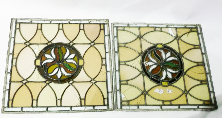 Pair leaded and stained glass panels, each square with stylised floral and foliate circular