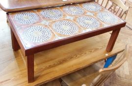 A modern tile-topped coffee table, rectangular with circular tiles on straight supports, 83cm wide