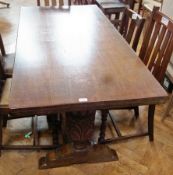 A modern oak dining table on foliate carved supports, united by stretcher, 163cm long