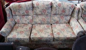 A modern three-piece suite comprising:- three seater sofa, and pair of armchairs in floral