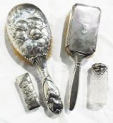 An Edwardian silver-mounted hairbrush, decorated with relief decoration of cherubs, London 1903,