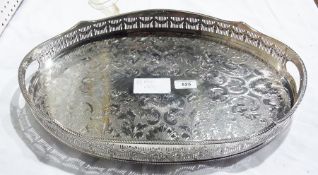 A large Sheffield-plated two-handled tray, oval, with foliate carved decoration and pierced