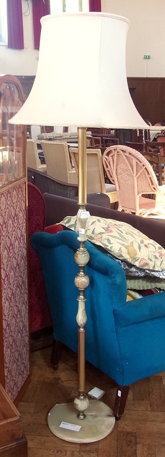 A brass and onyx standard lamp, with cream shade