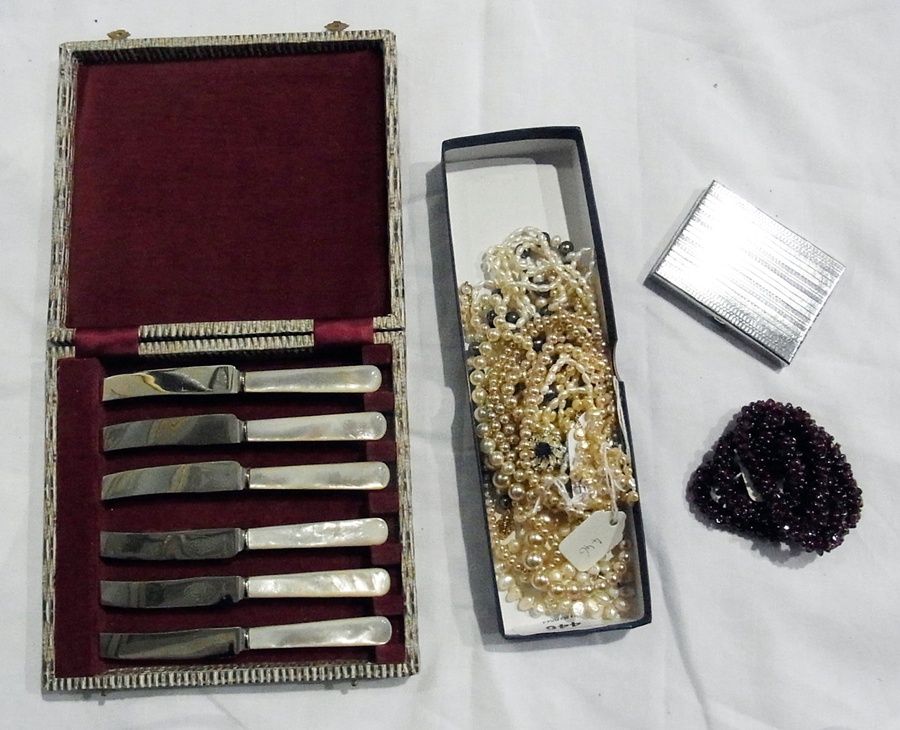 Silver-plated candelabrum, six mother-of-pearl handled tea knives and a white metal compact, four