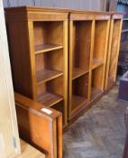 A modern mahogany bookcase on plinth base, 130cm wide, a pair of matching bookcases on plinth